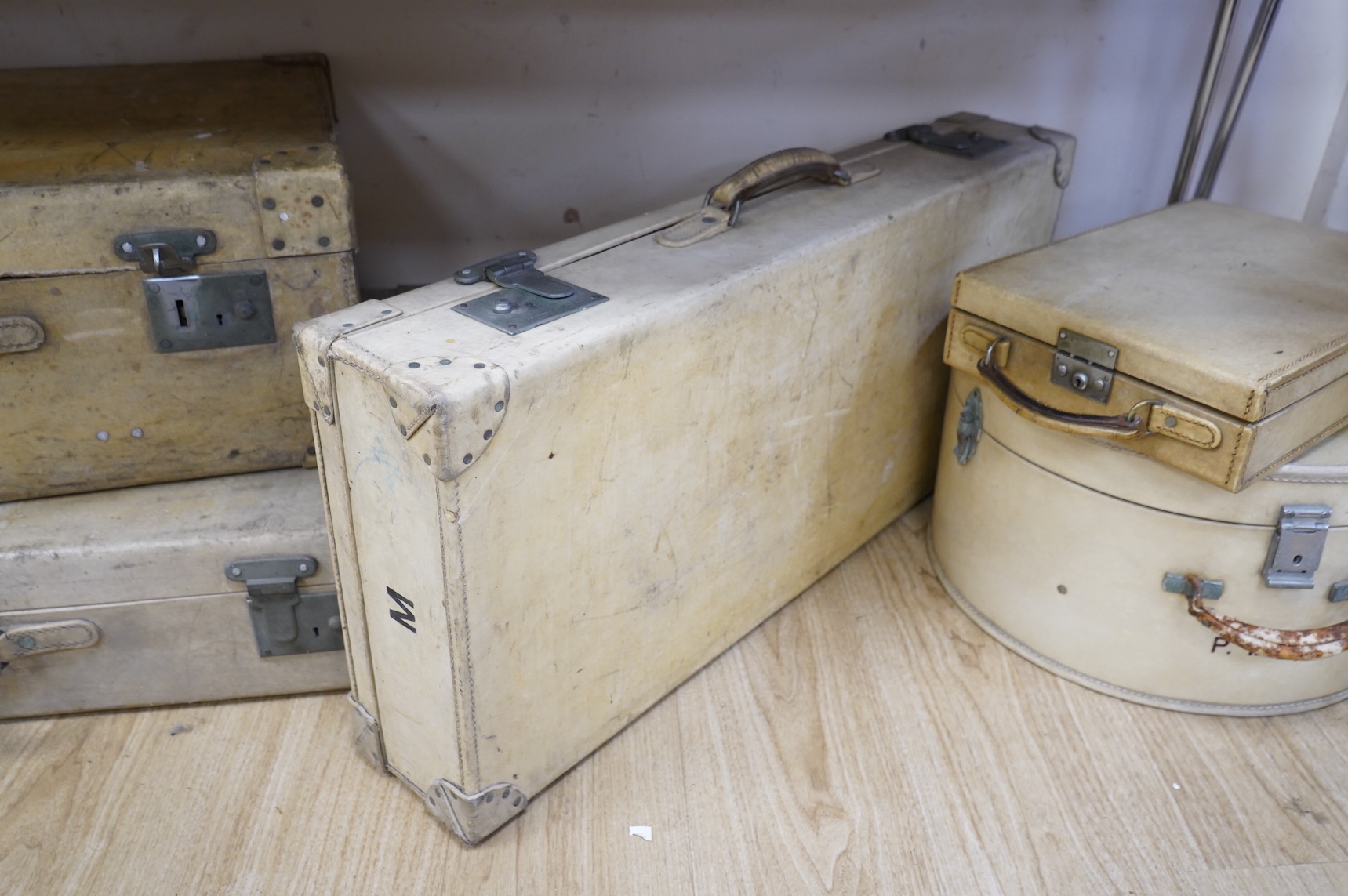 A collection of luggage comprising four vintage trunks and a hat box